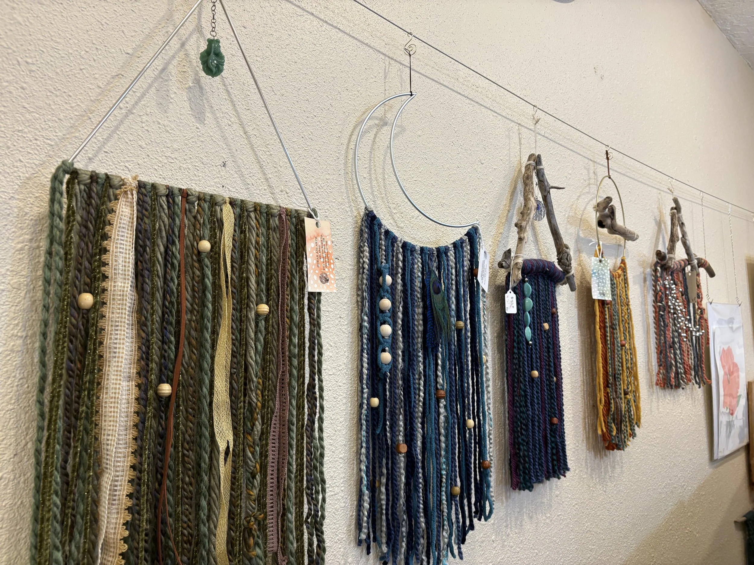 driftwood, yarn, beads, and other embellishment wall hangings