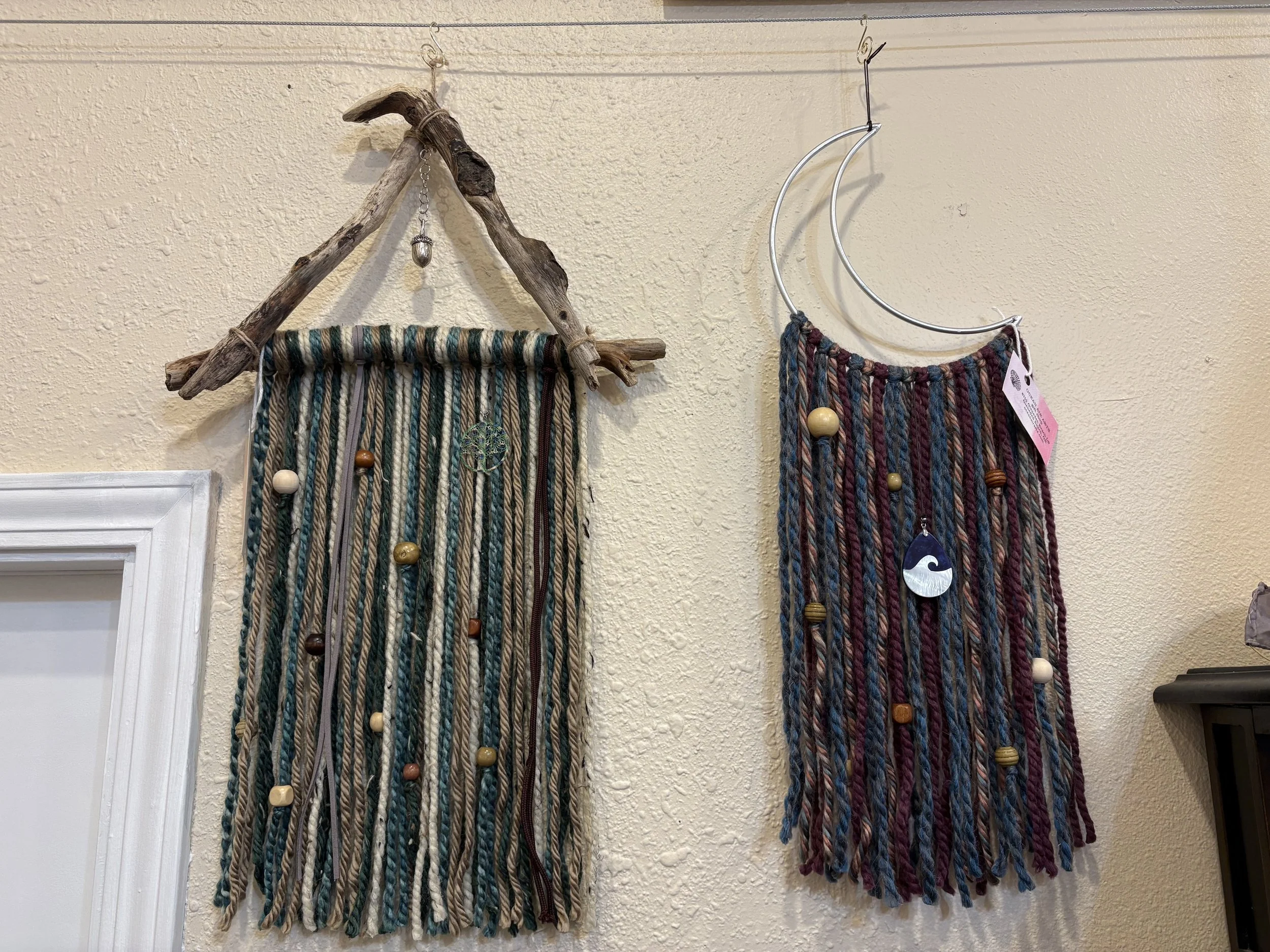 driftwood, yarn, beads, and other embellishment wall hangings