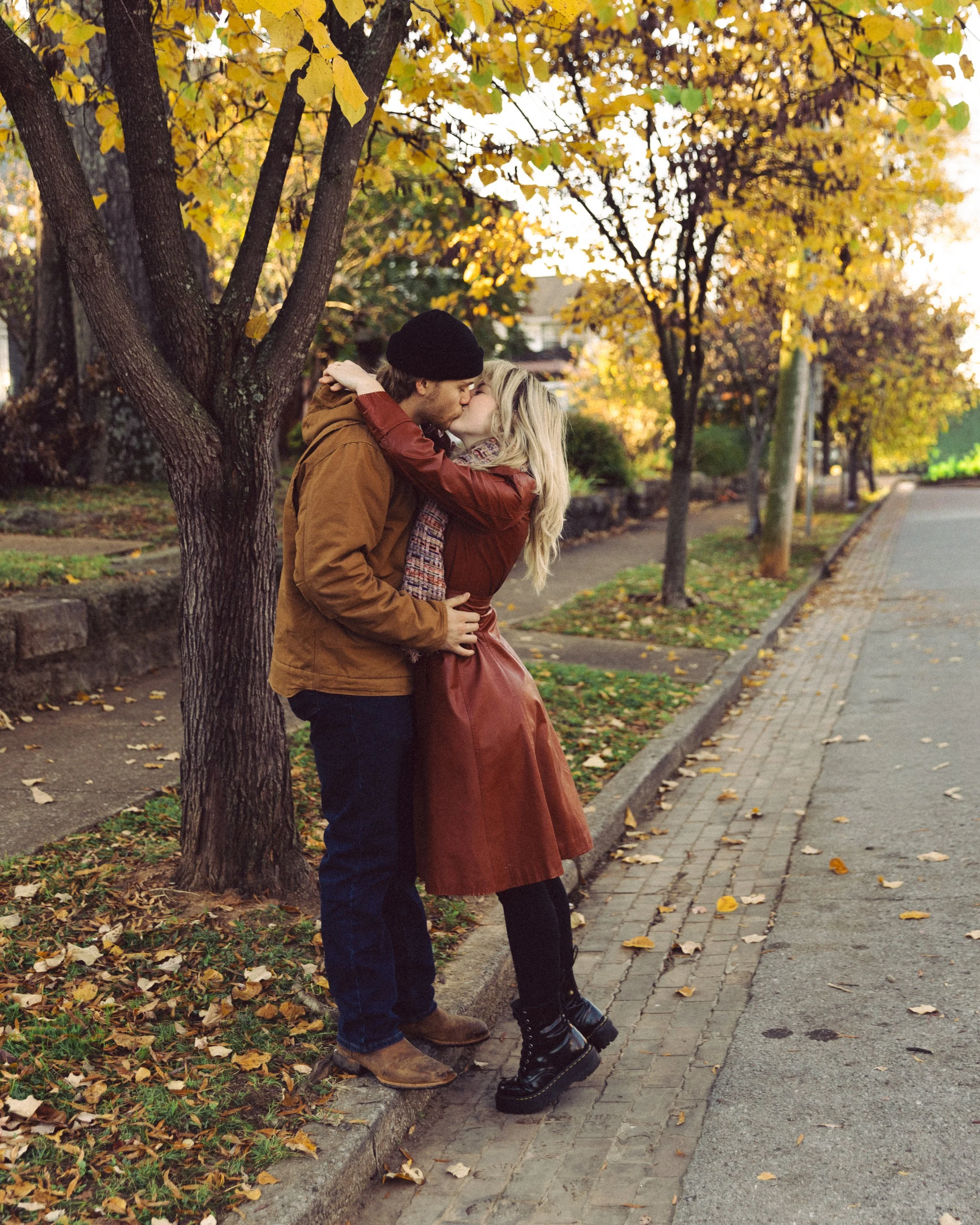 Couple kissing each other during fall season