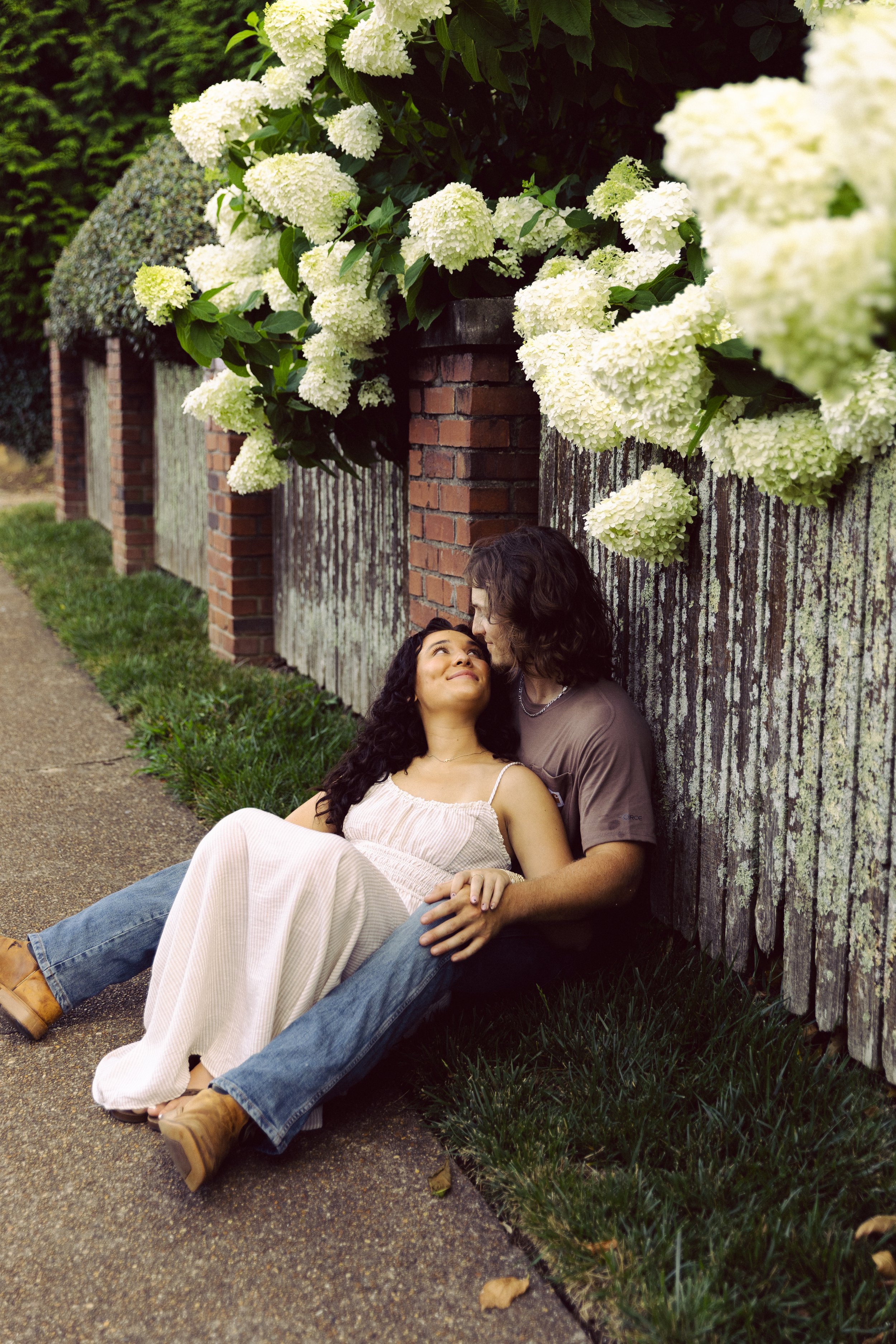 couple sitting on the sidewalk