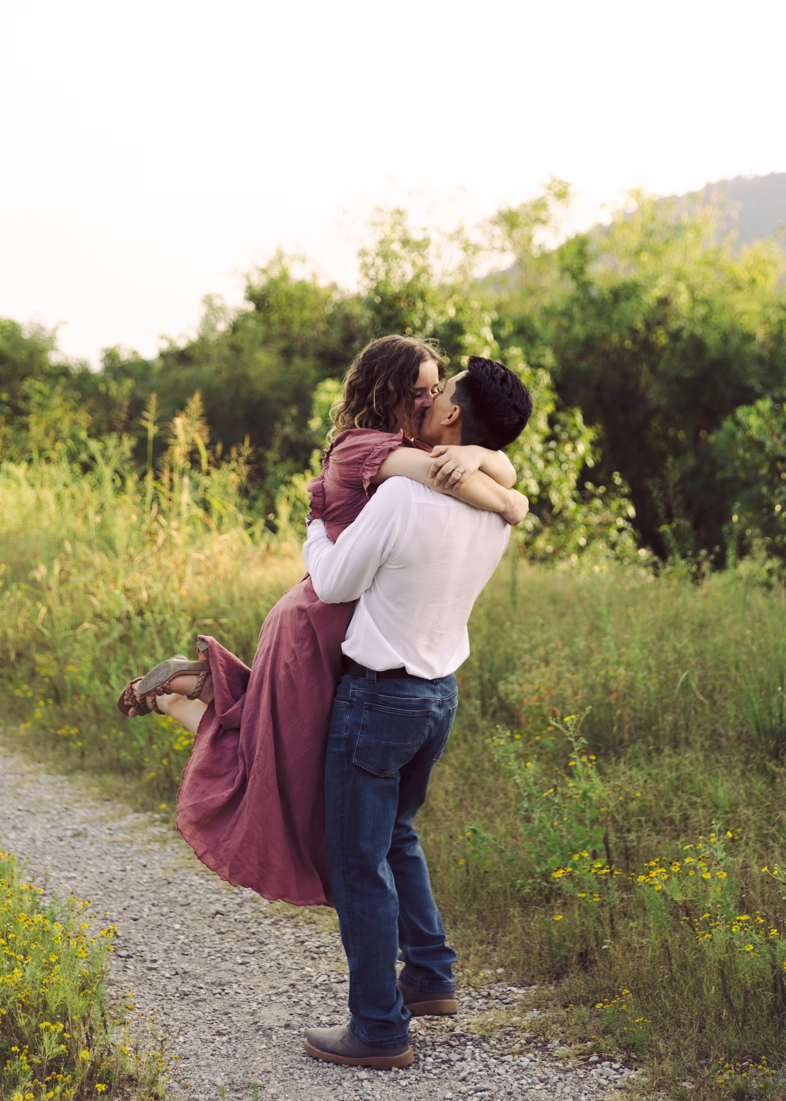 Couple kissing in grass field