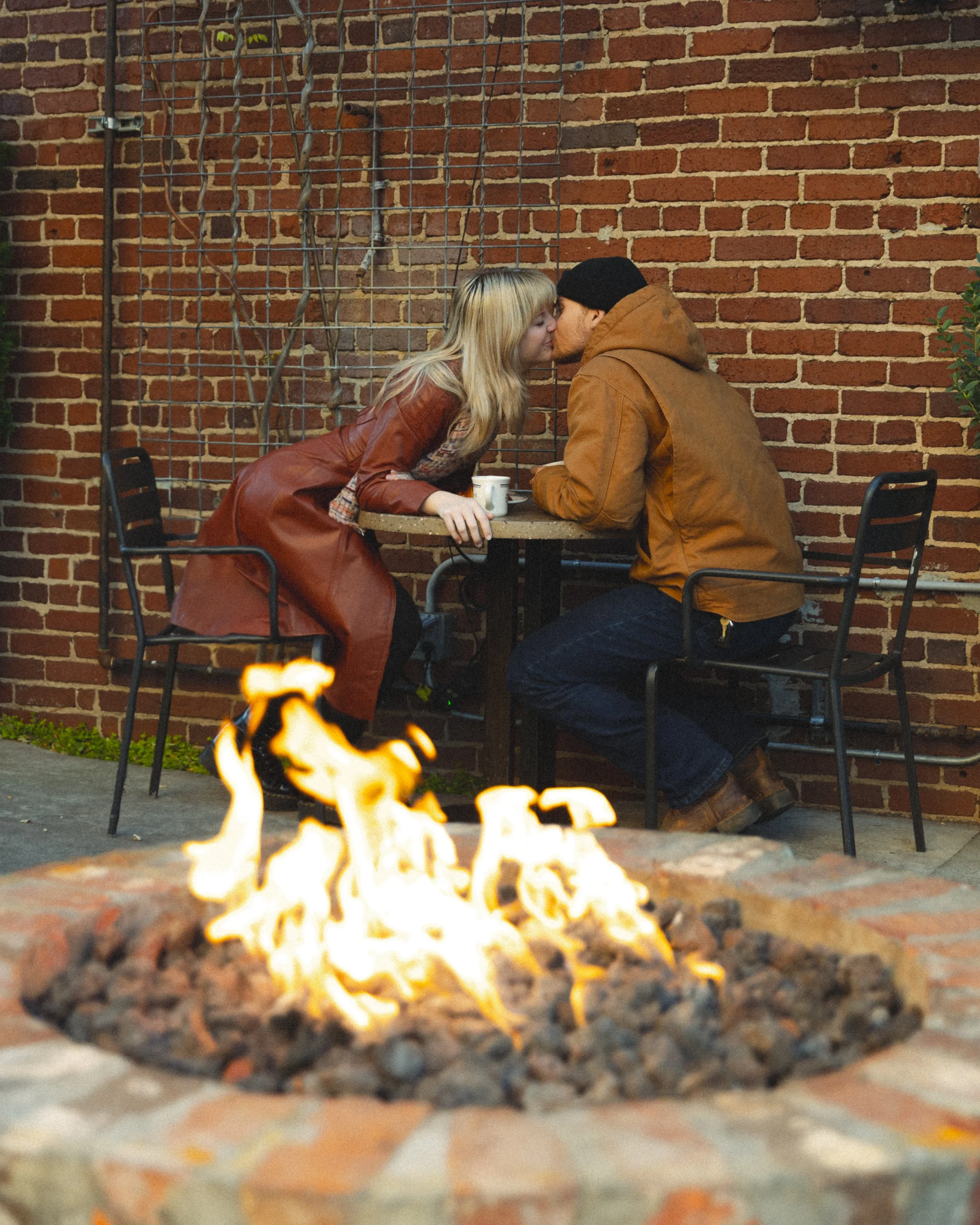 Couple kissing at a coffee shop
