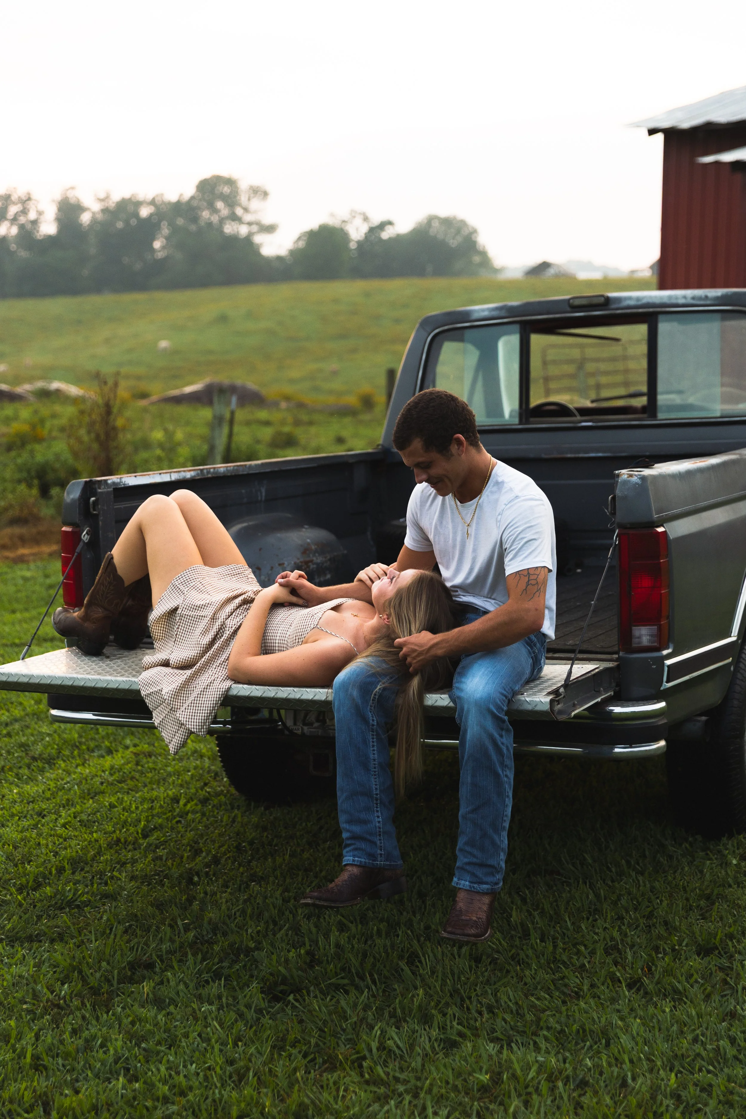 Couple sitting on back of truck