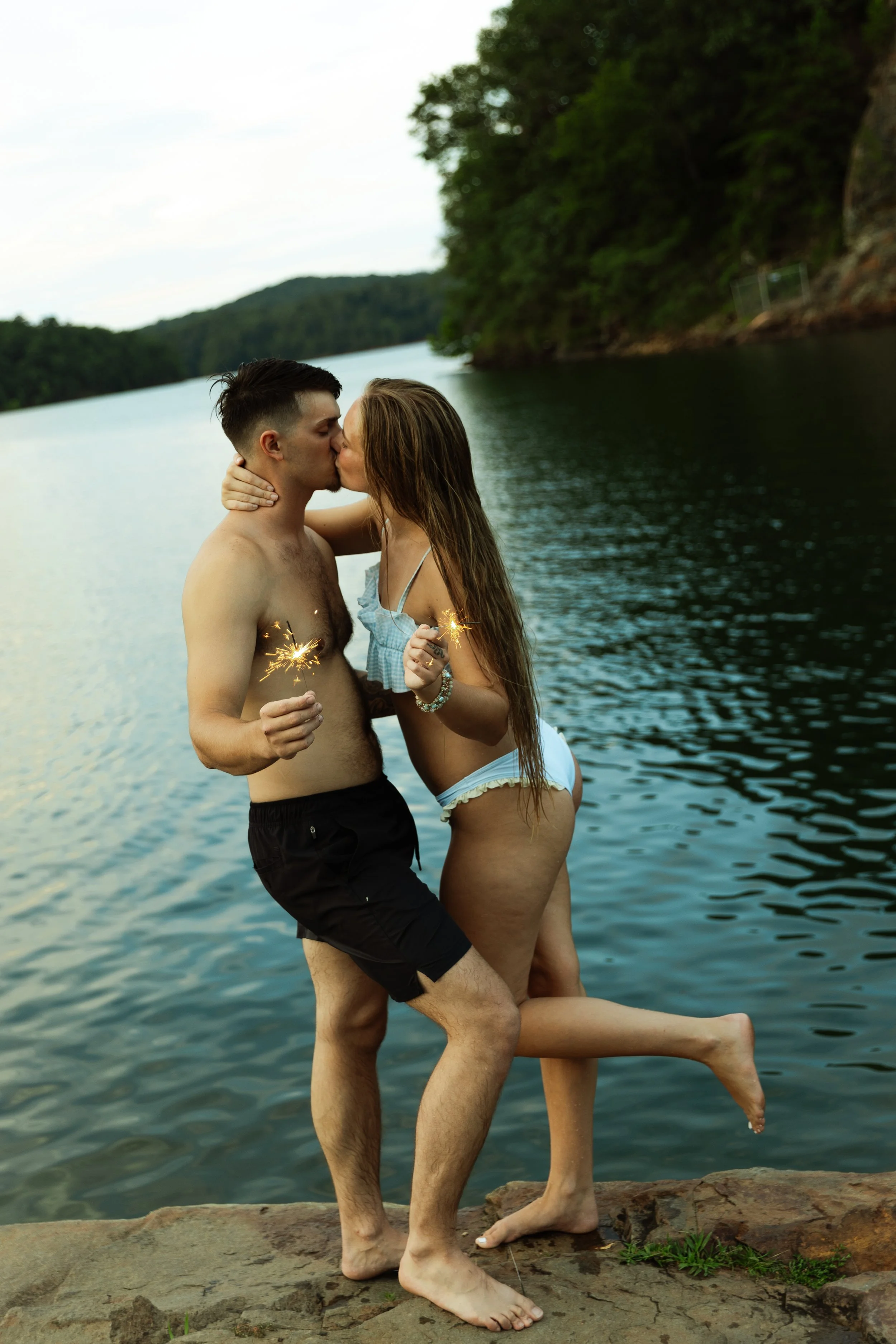 Couple kissing with sparklers
