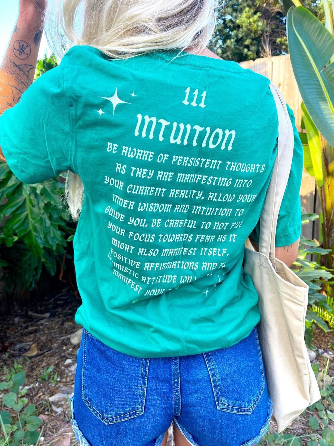 A close up shot of the back of go cozy’s Kelly green intuition tee