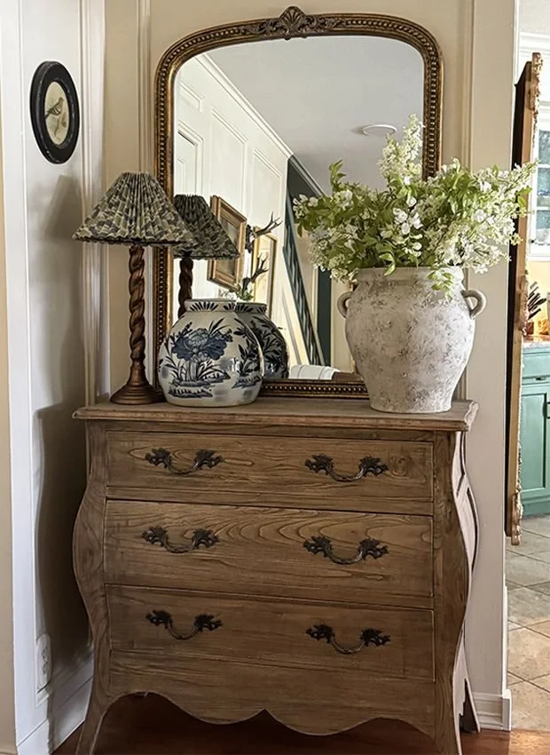 vintage dresser styled by entryway in home