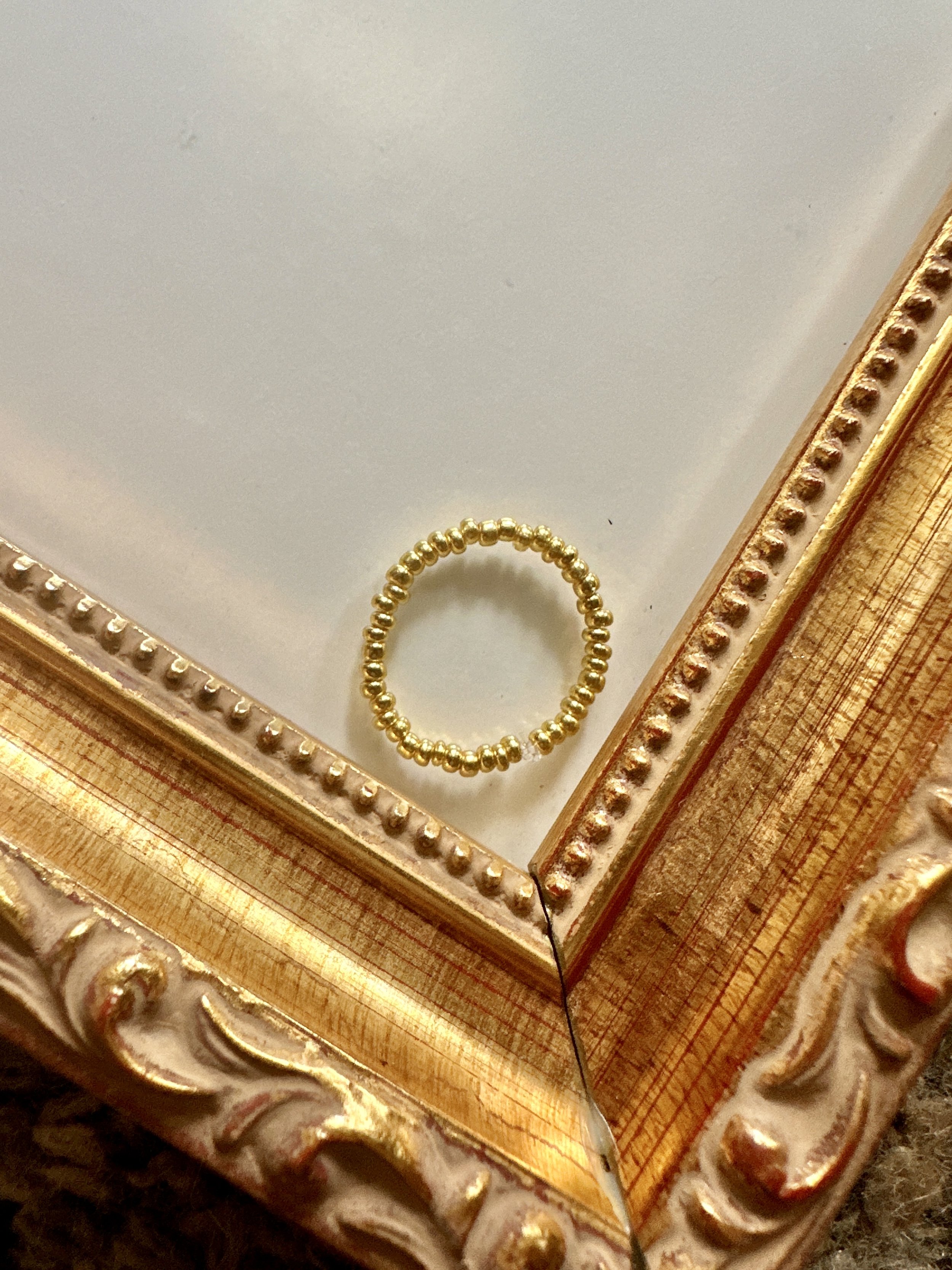 dainty gold beaded stretch ring that fits ring sizes 5 through 8.