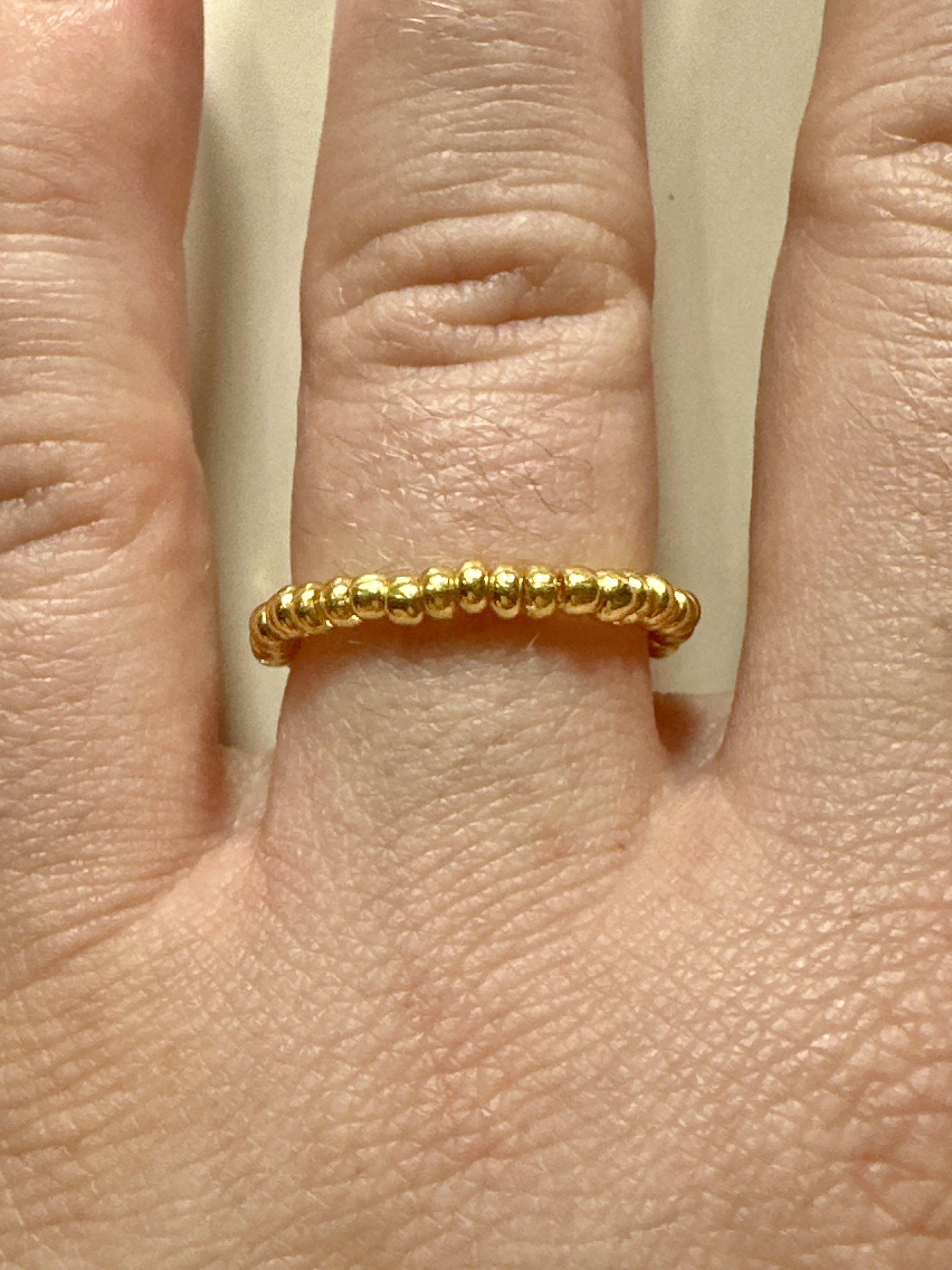 dainty gold beaded vintage ring worn on hand on the wedding ring finger