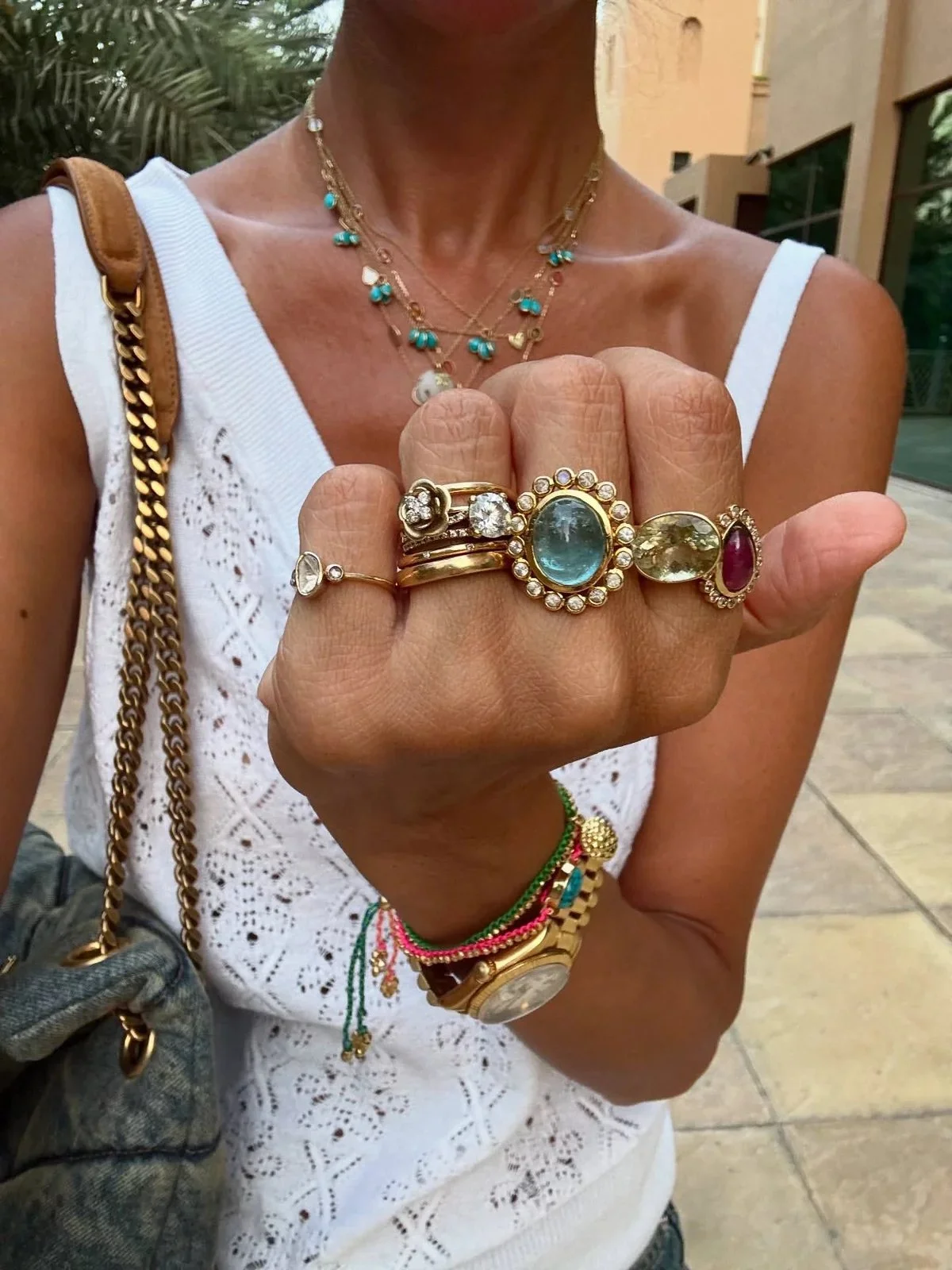 various gold jewelry pieces stacked including rings, bracelets and necklaces