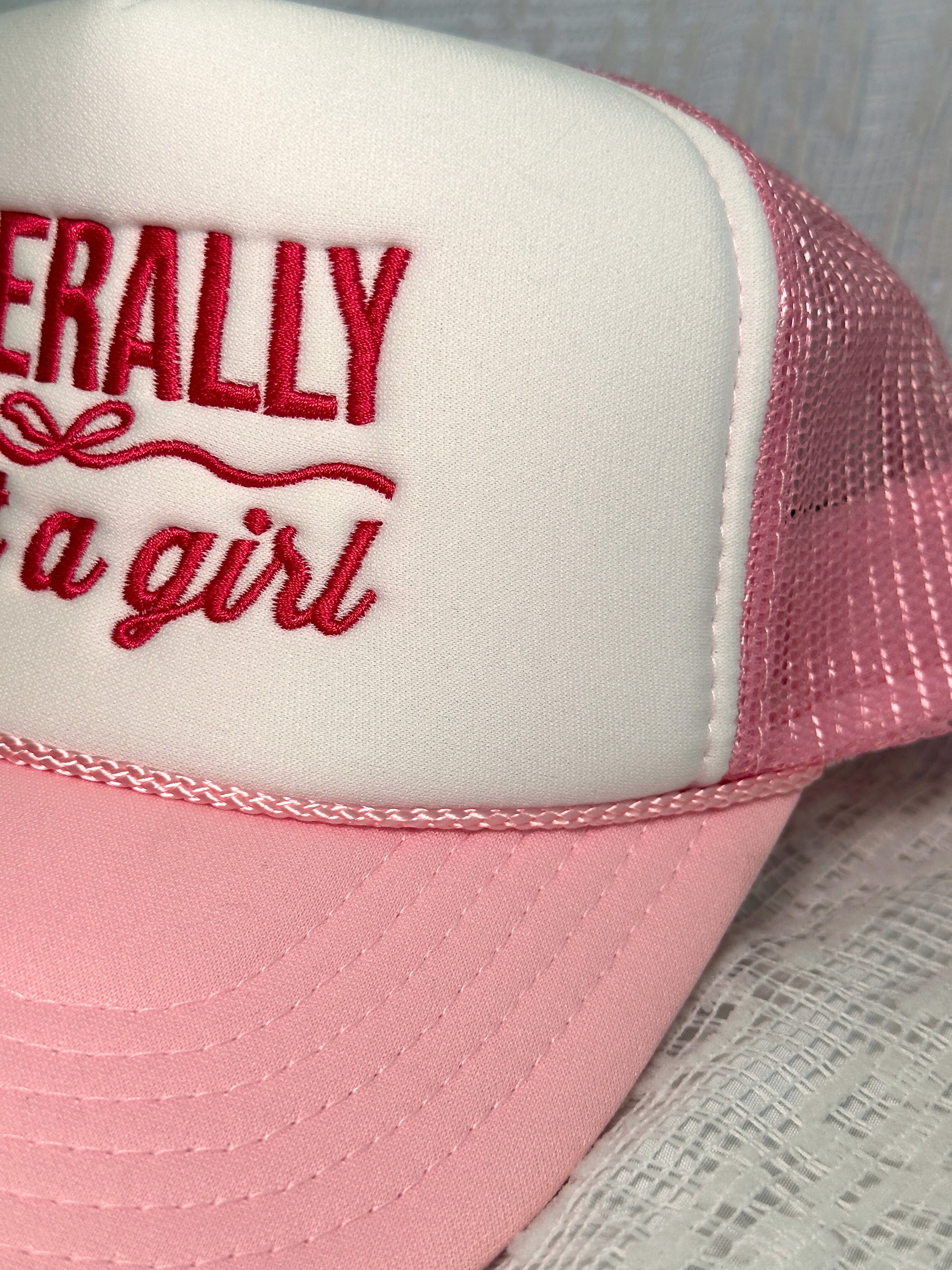 close up photo of just a girl embroidered trucker hat with rope braid detail on the cap
