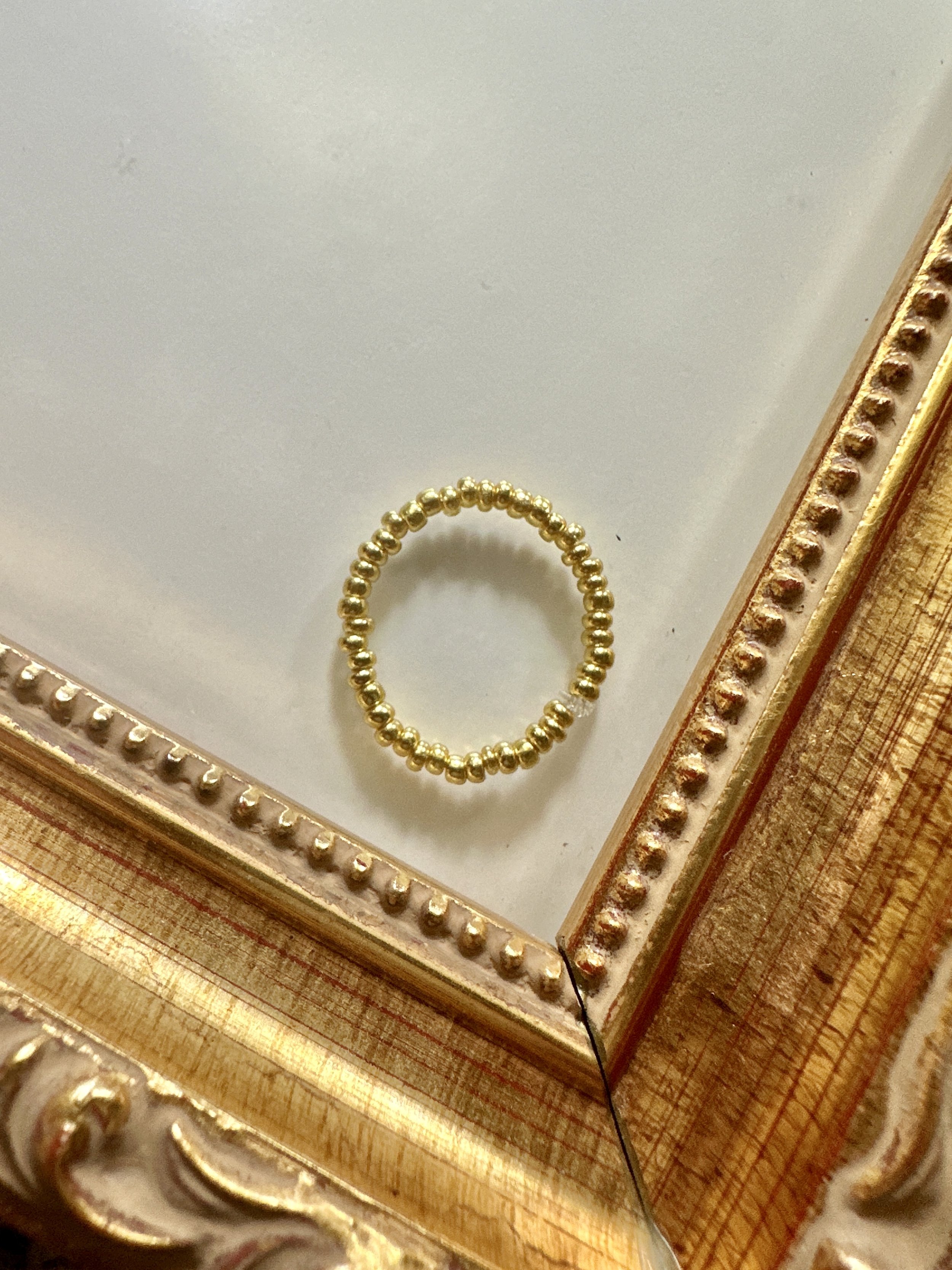 a super dainty gold beaded stretch ring for women