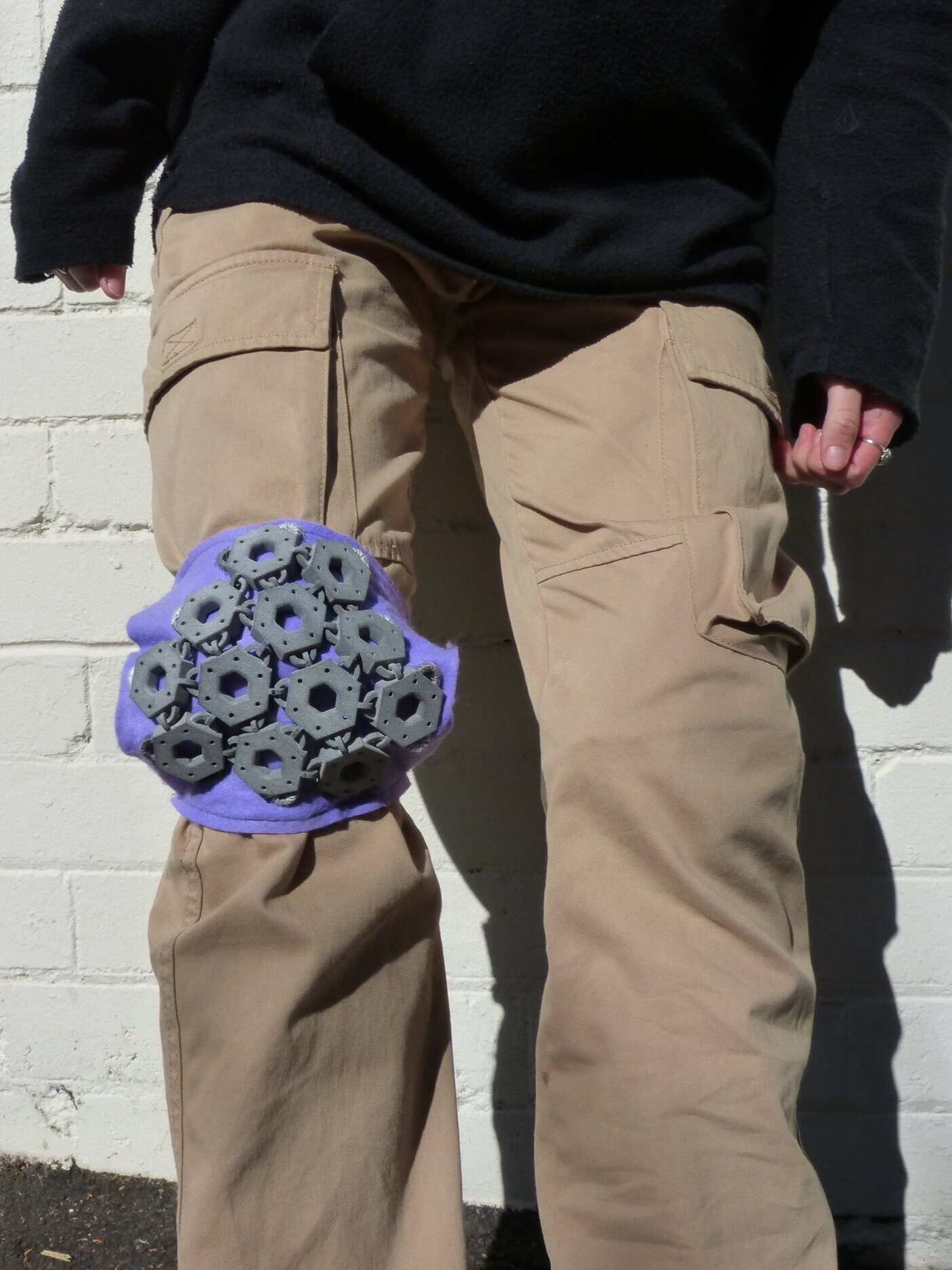 The knee pads are thin so they can go over or under the users' pants if they desire more discretion