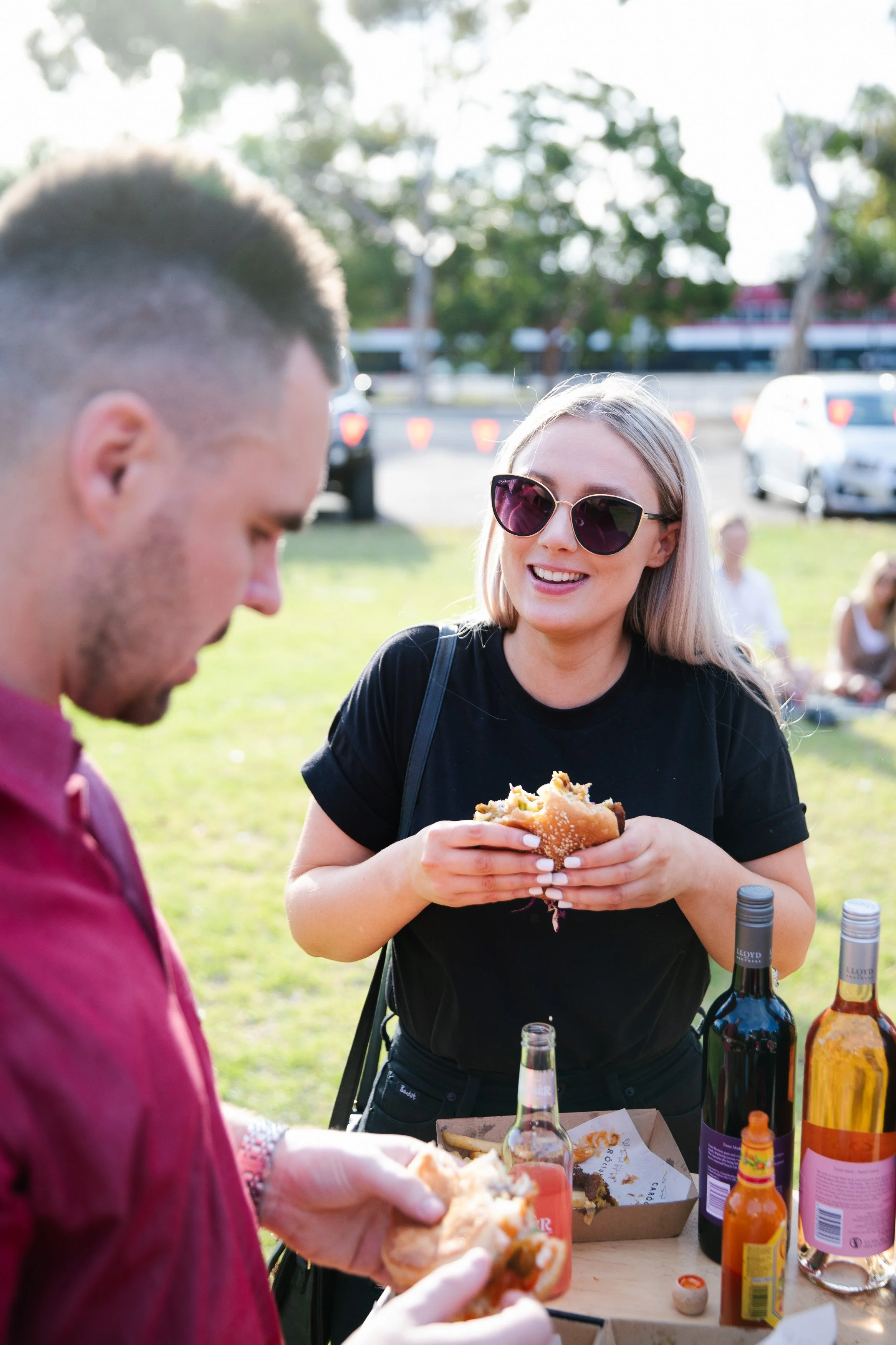 wedding guests enjoying CaroClub burgers and wine