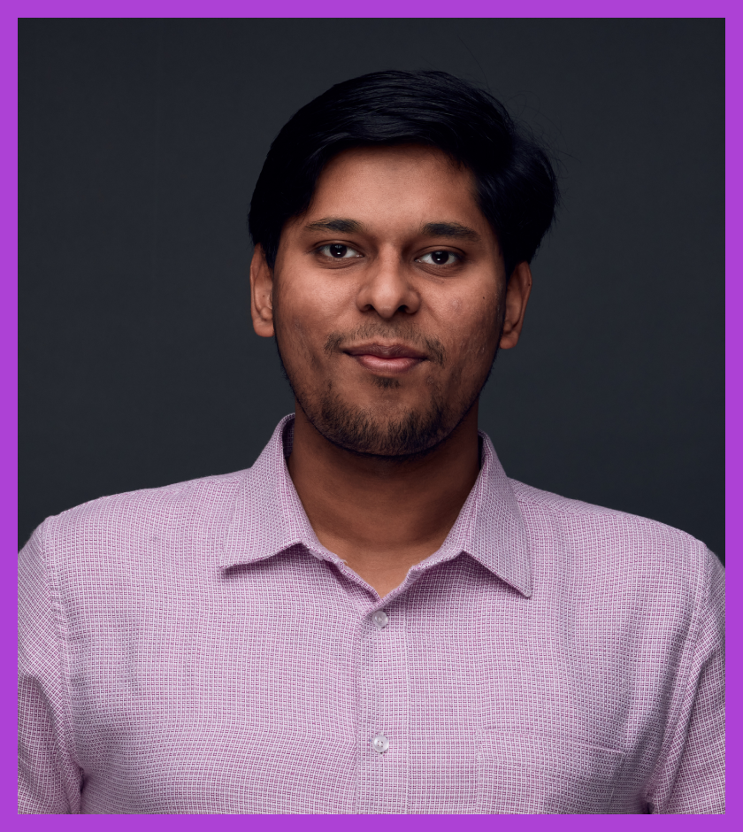 Kunal is an Indian male with short dark hair and dark brown eyes, wearing a pink shirt, and slightly smiling at the camera.