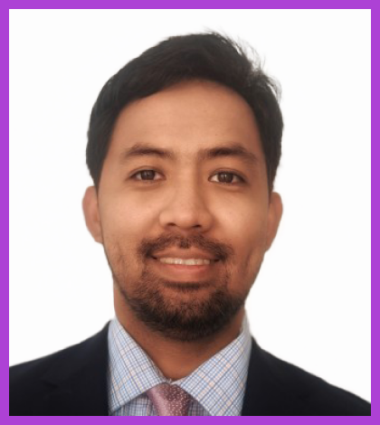 Headshot of Allan - Allan has medium tone skin, dark hair and beard. He is wearing a formal suit and smiling at the camera.