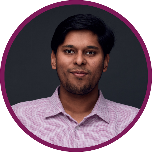 Kunal is an Indian male with short dark hair and dark brown eyes, wearing a pink shirt, and slightly smiling at the camera.