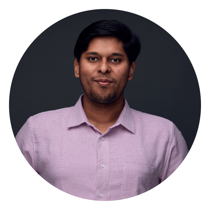 Kunal is an Indian male with short dark hair and dark brown eyes, wearing a pink shirt, and slightly smiling at the camera.