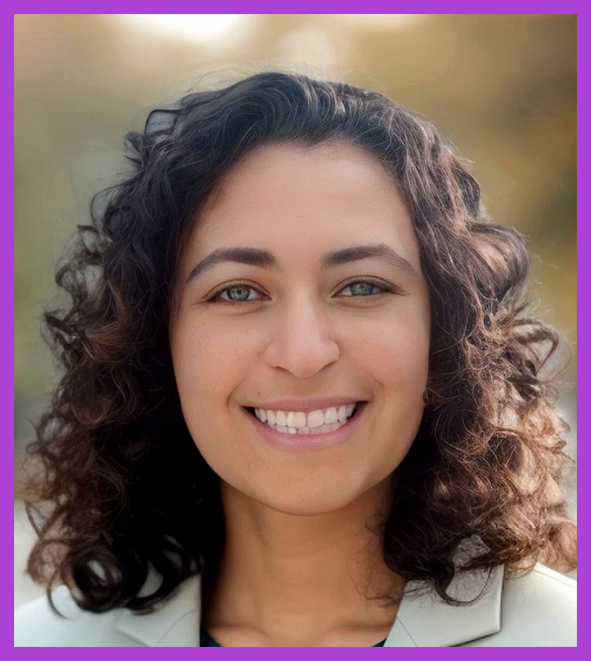 Headshot of Maia - Maia is white with brown, shoulder-length curly hair and is smiling at the camera.