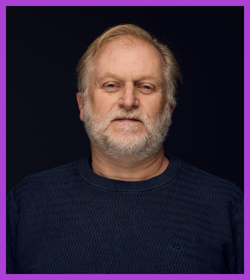 Ben is a middle-aged Caucasian male with short blond hair and grey beard. Ben is wearing a navy jumper and looking at the camera.
