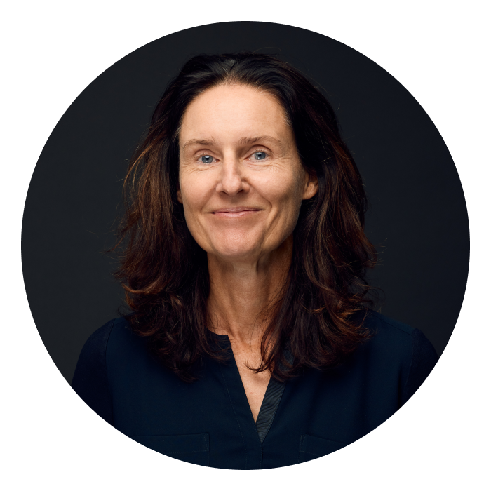Headshot of Barbara - a Caucasian woman with brown hair and wearing a navy top, slightly smiling at the camera.