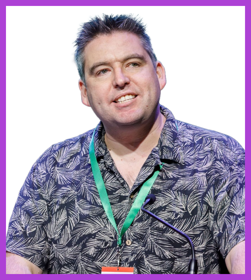 Aaron is a middle-aged white male, with dark brown hair. He is wearing a green floral shirt.