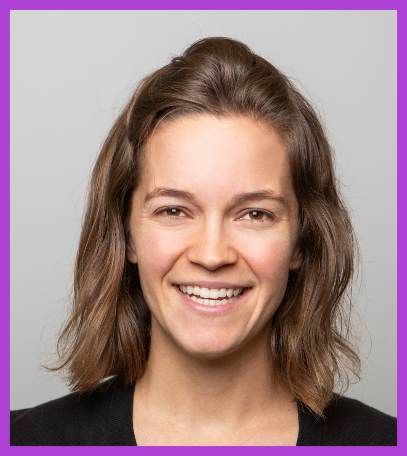 Headshot of Lauren - a Caucasian woman with light brown hair wearing a blue top and black cardigan, smiling at the camera.