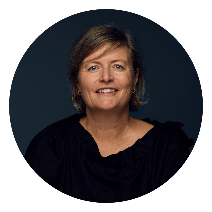 Rachel Collingridge is a middle-aged Caucasian woman with should length dark blonde hair & hazel eyes. She is wearing a black top and smiling at the camera..