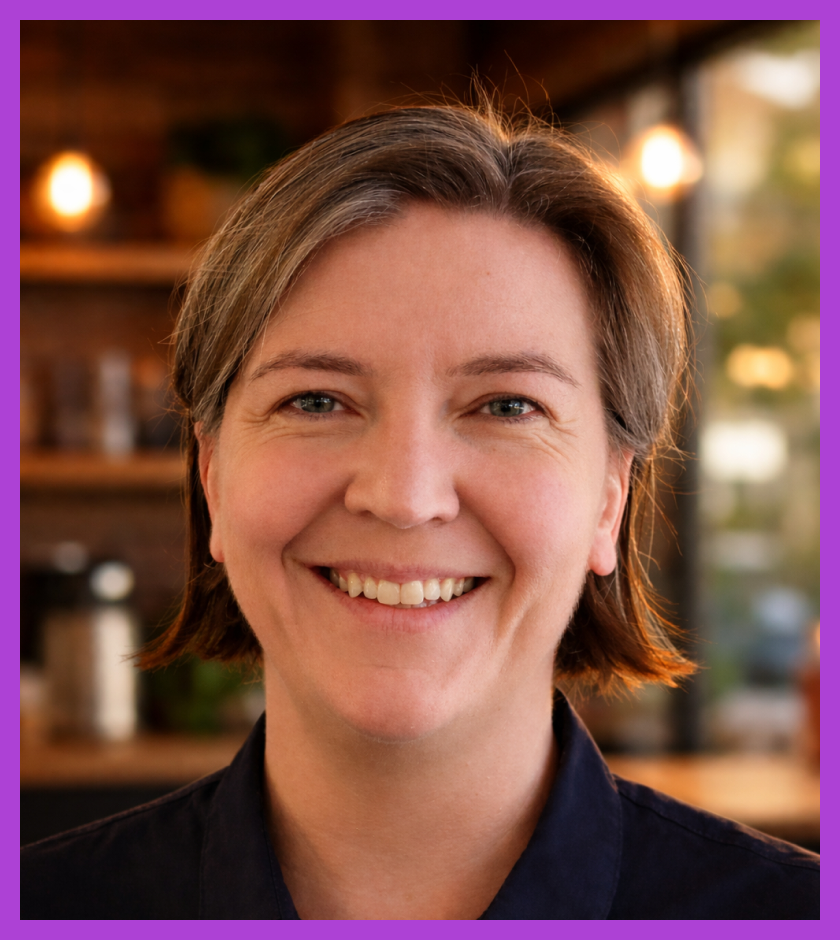 Karen is a middle-aged Caucasian woman, who light brown shoulder length hair. She is wearing a navy top & smiling at the camera.