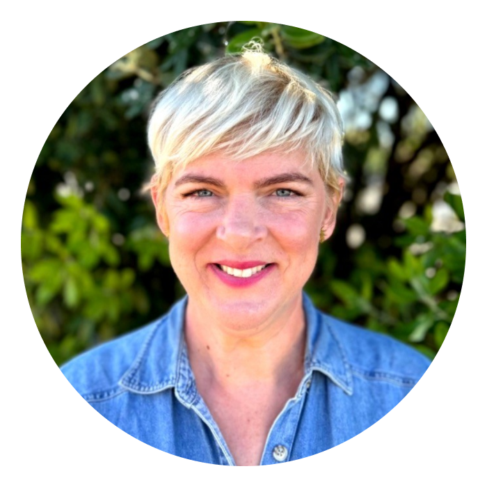 Headshot of Racheal - a Caucasian woman with blonde hair and wearing a light blue shirt, smiling at the camera.
