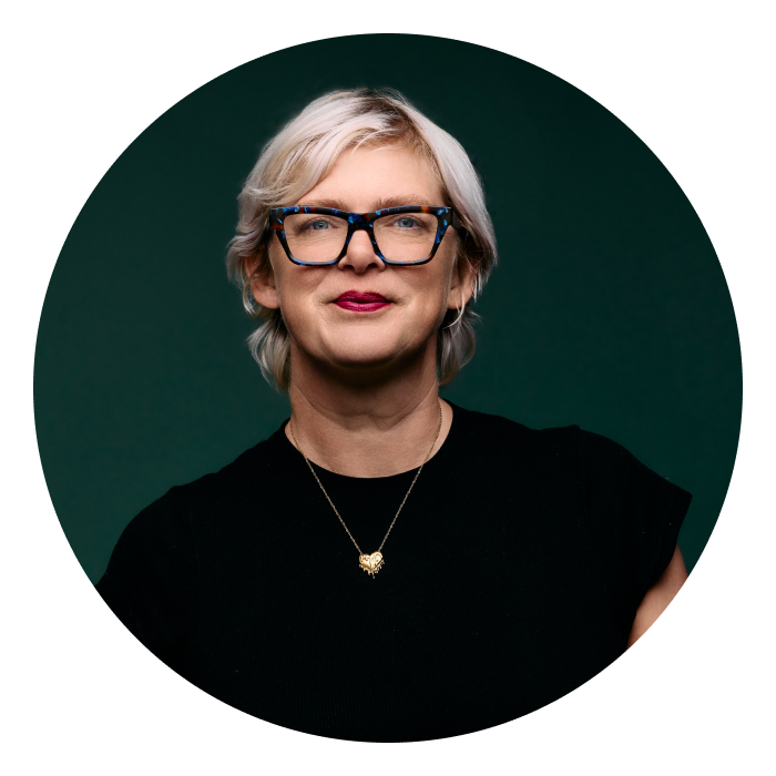 Racheal is a Caucasian woman with blonde hair and wearing a black top, smiling at the camera.