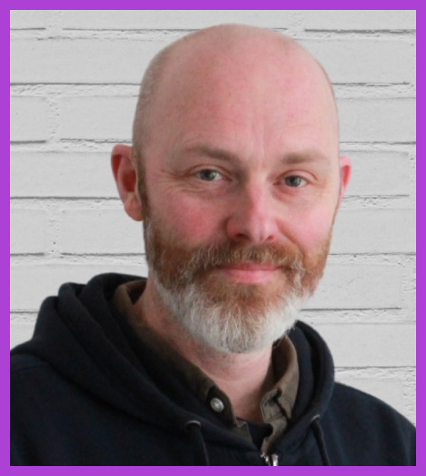 Headshot of Steve Barnett - middle-aged white man, bald, brown beard with white bits, in his uniform of shirt and black hoodie