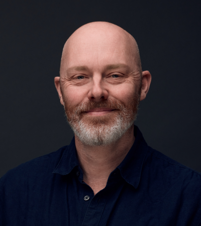 Headshot of Steve Barnett - middle-aged white man, bald, brown beard with white bits, wearing a dark navy shirt.