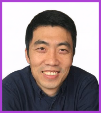 Feilong is a middle-aged Chinese man, wearing a navy blue shirt and smiling at the camera.