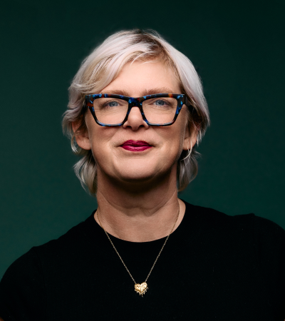 Racheal is a Caucasian woman with blonde hair and wearing a black top, smiling at the camera.