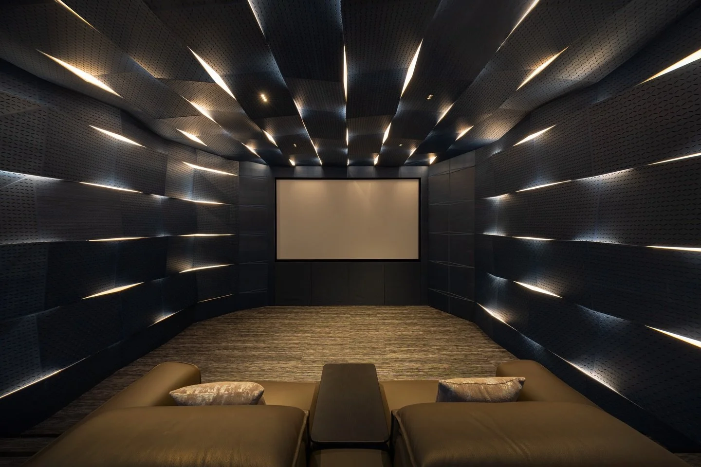 Shou Sugi House

In the basement, the space is transformed into a dedicated home theatre. The room is lined with customised indigo blue-stained birch veneered panels arranged within a precise grid. Within this system, the geometry is subtly manipulat