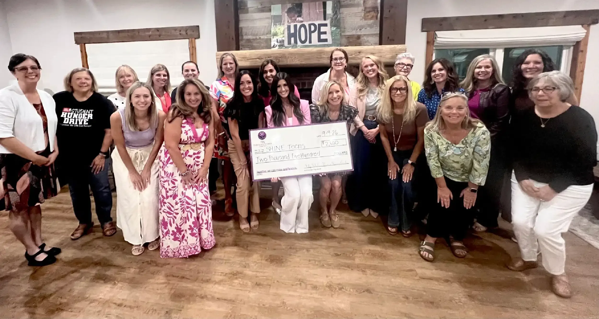 The Charlotte chapter of FFWGC gathered around a large check made out to Shine Teens