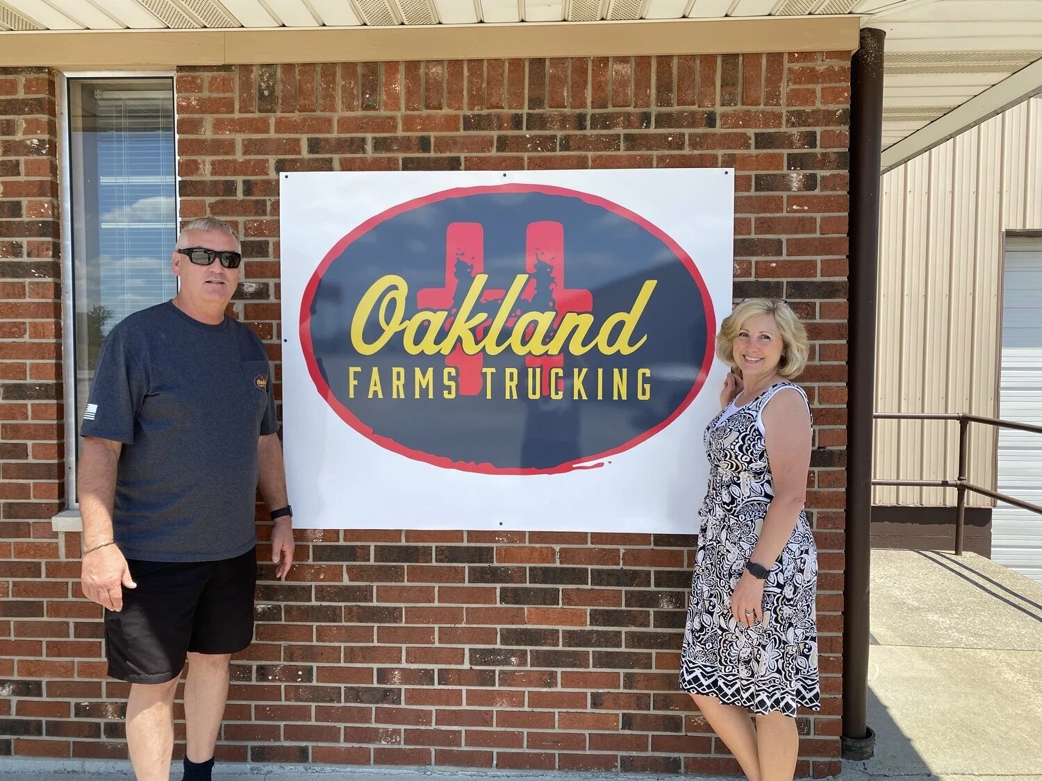 Owners Brent and Carla with our fresh sign! 