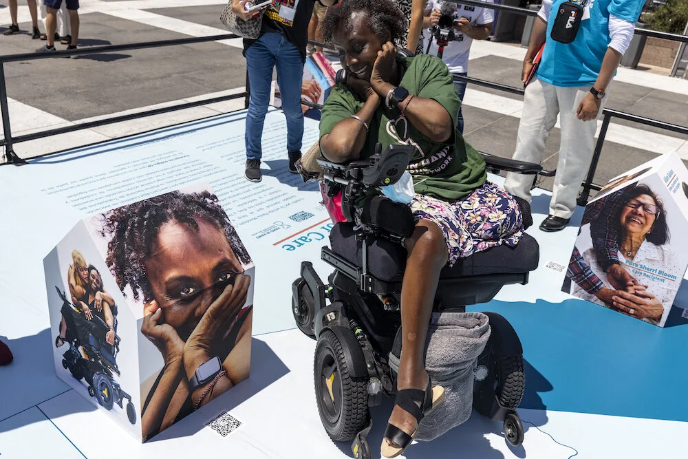 Disability activist Engracia Figueroa recreates the pose she used in one of the photos in Communities of Care.