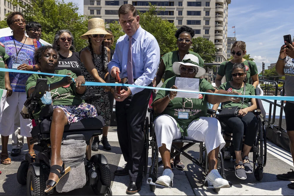 Labor Secretary Marty Walsh and artist Paola Mendoza cut the ribbon to officially open the Communities of Care Installation.