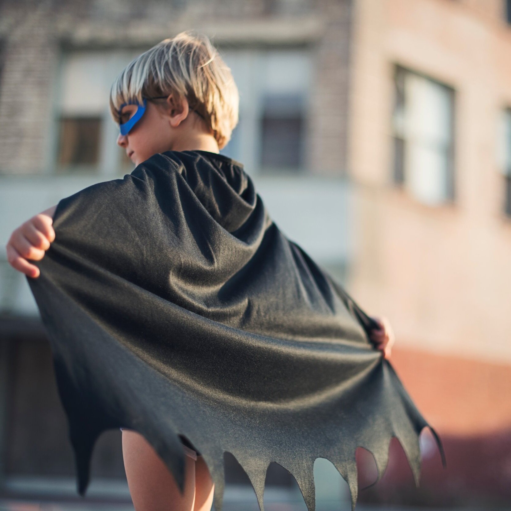 Little boy in black cape, photo by TK Hammonds on Unsplash