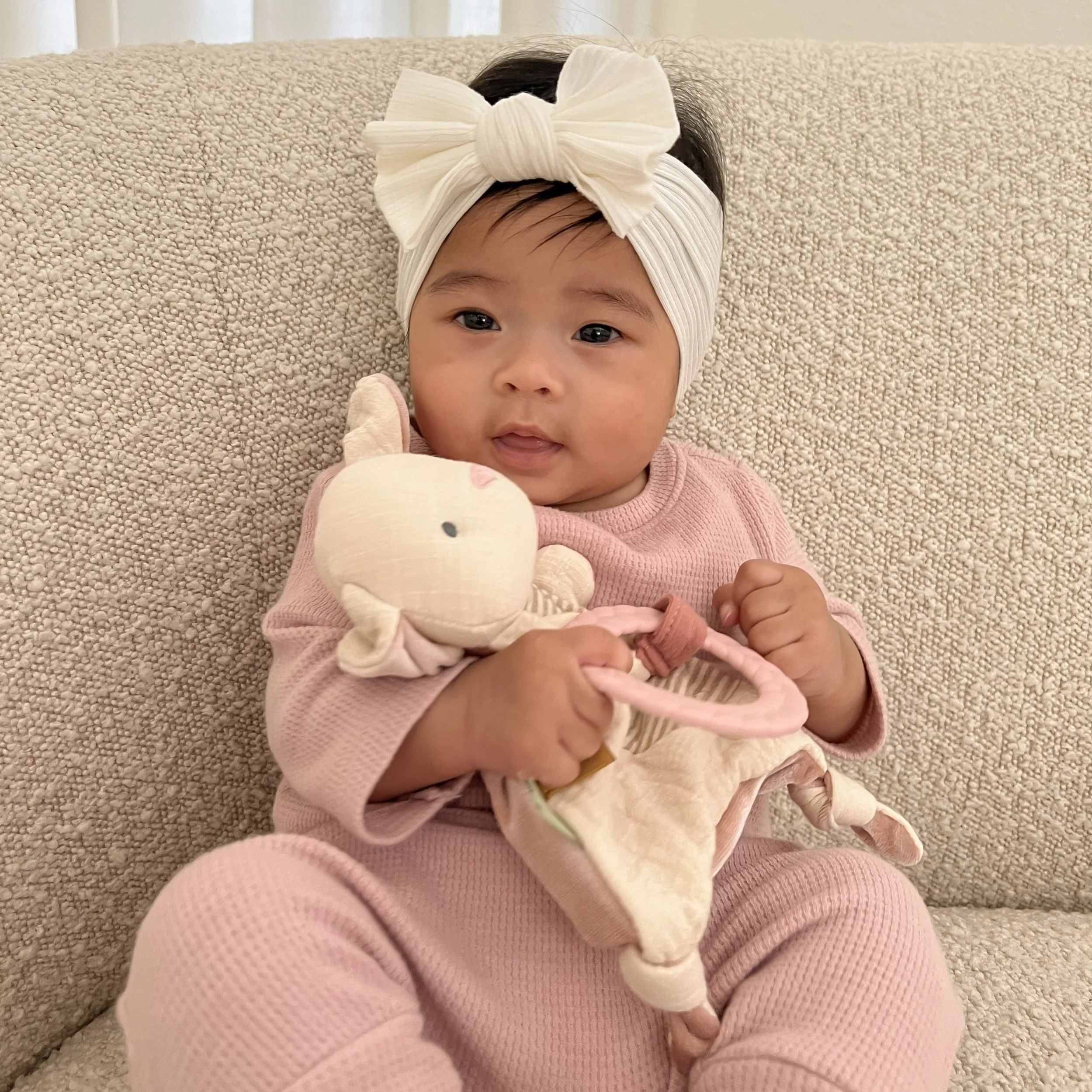 Sweet little girl holding the Bitsy Crinkle Bunny.