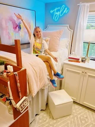 White upholstered headboard in cute dorm room.