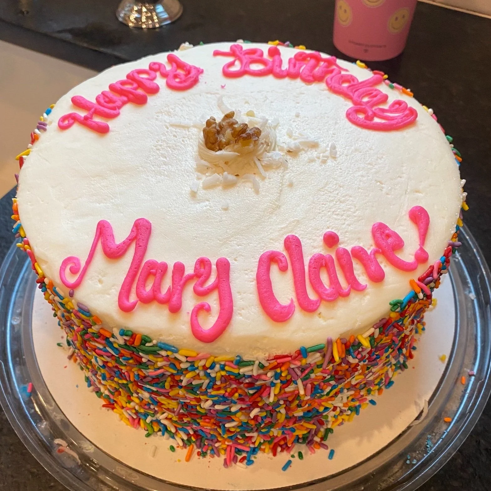 Italian Cream Cake with sprinkles on sides and hot pink Happy Birthday on top!
