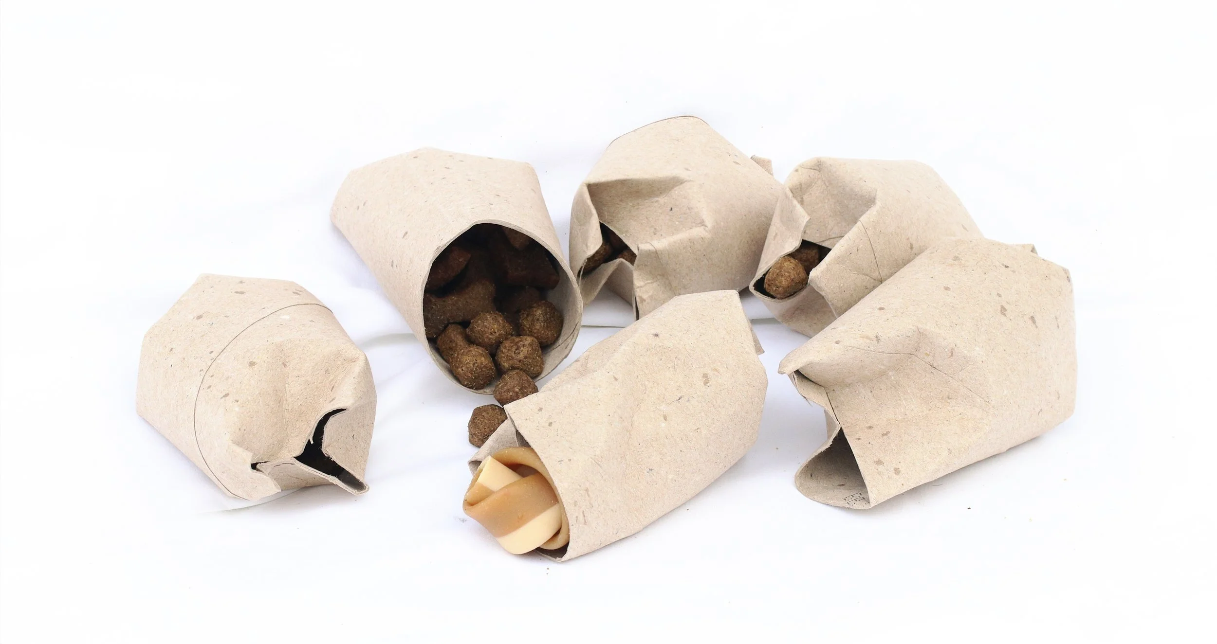Cardboard toilet roll tubes filled with treats and chews.