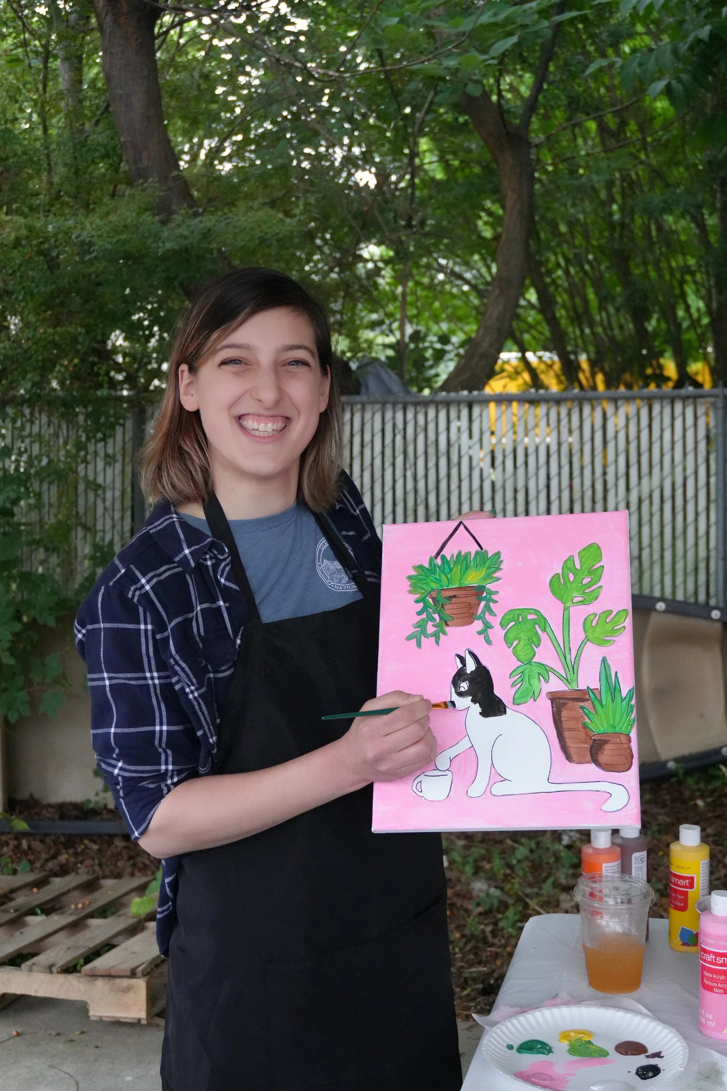 Paint & Sip host, Taylor Varron, demonstrating how to paint a cat