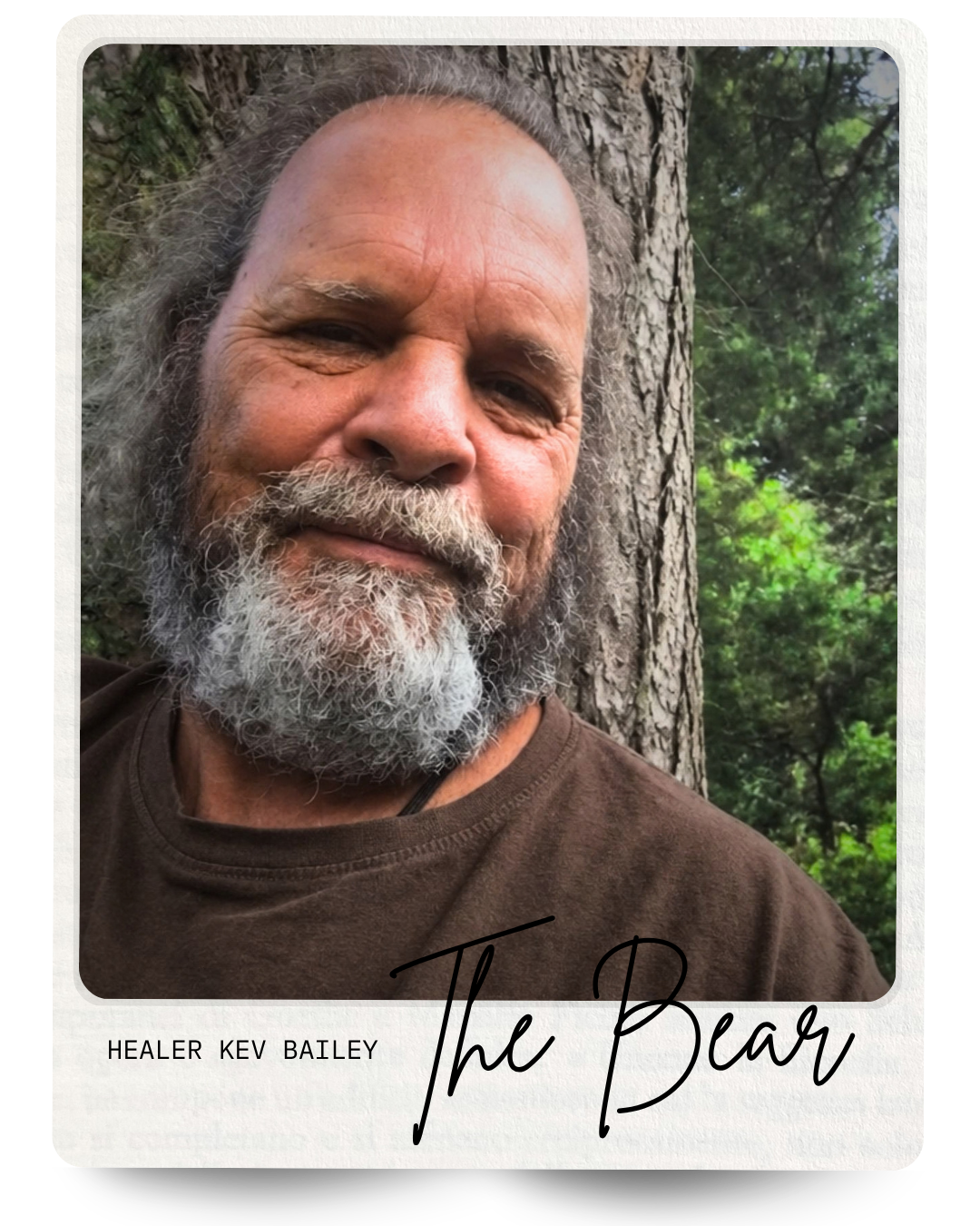 Healer Kev Bailey leaning against a pine tree.