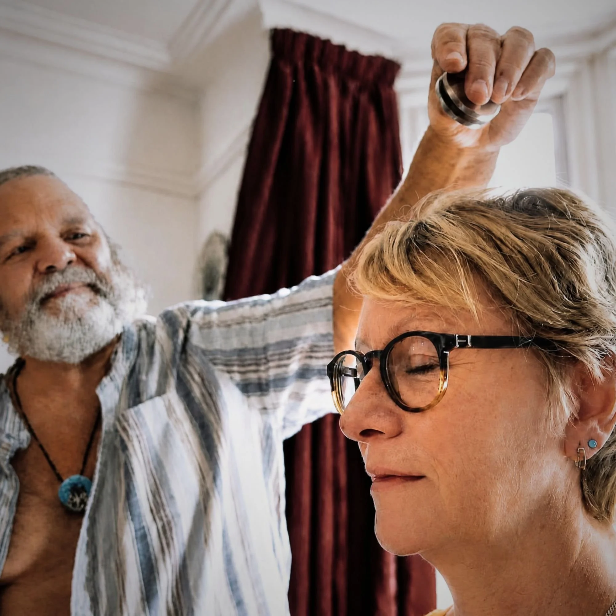 Holistic healer Kev Bailey using kinesiology to test a client.