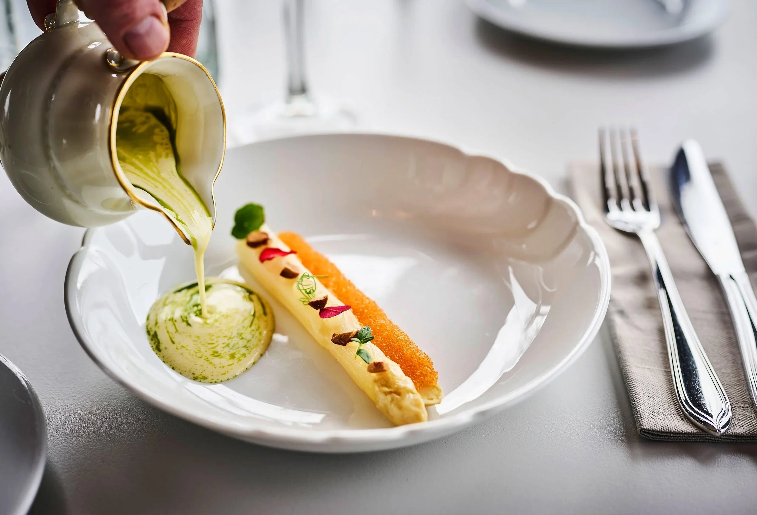 Close-up of decorative vegetables in gourmet style covered in yellow sauce