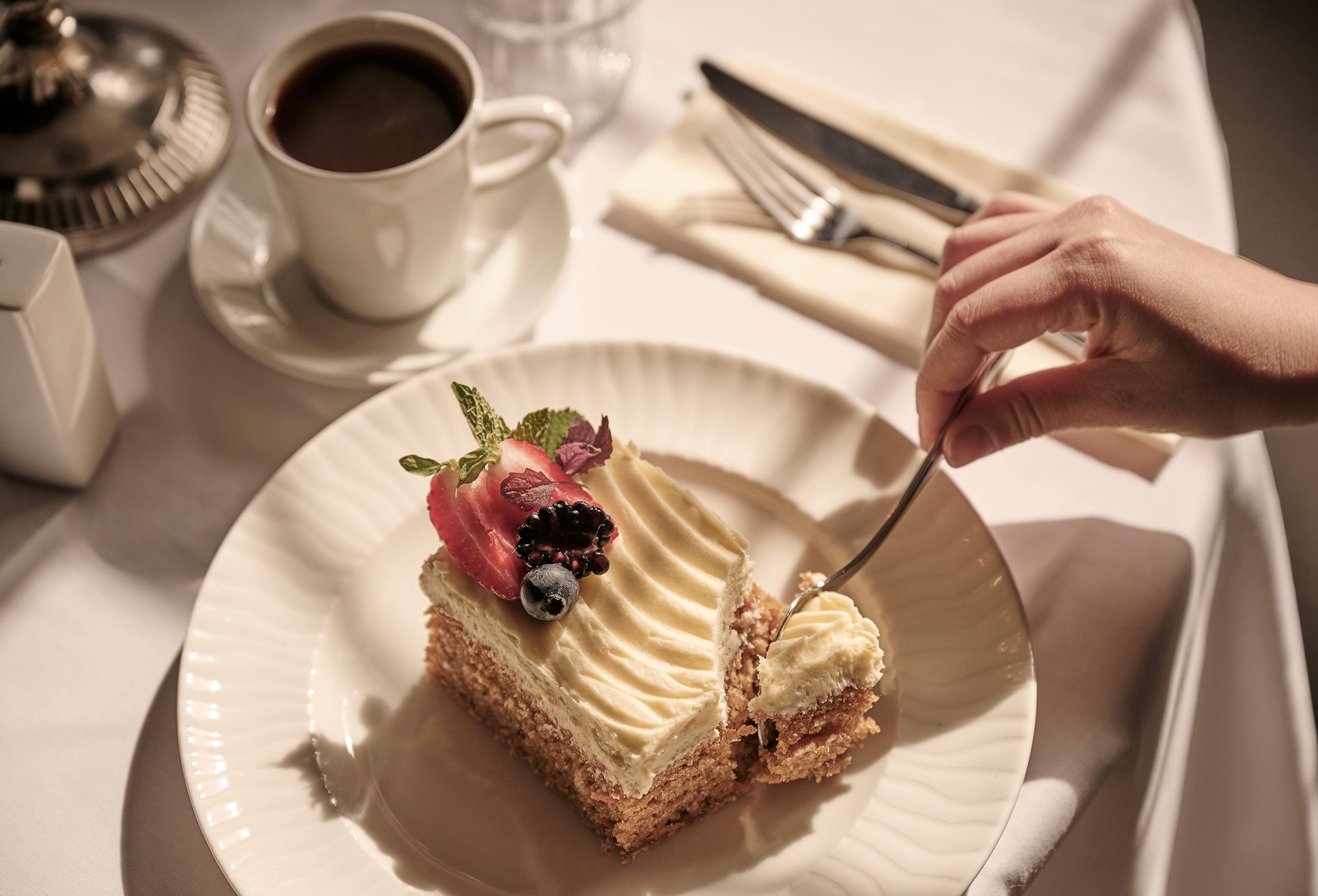 Close-up of delicious sponge cake with strawberry garnish from the restaurant at Sola Strand Hotel and Spa