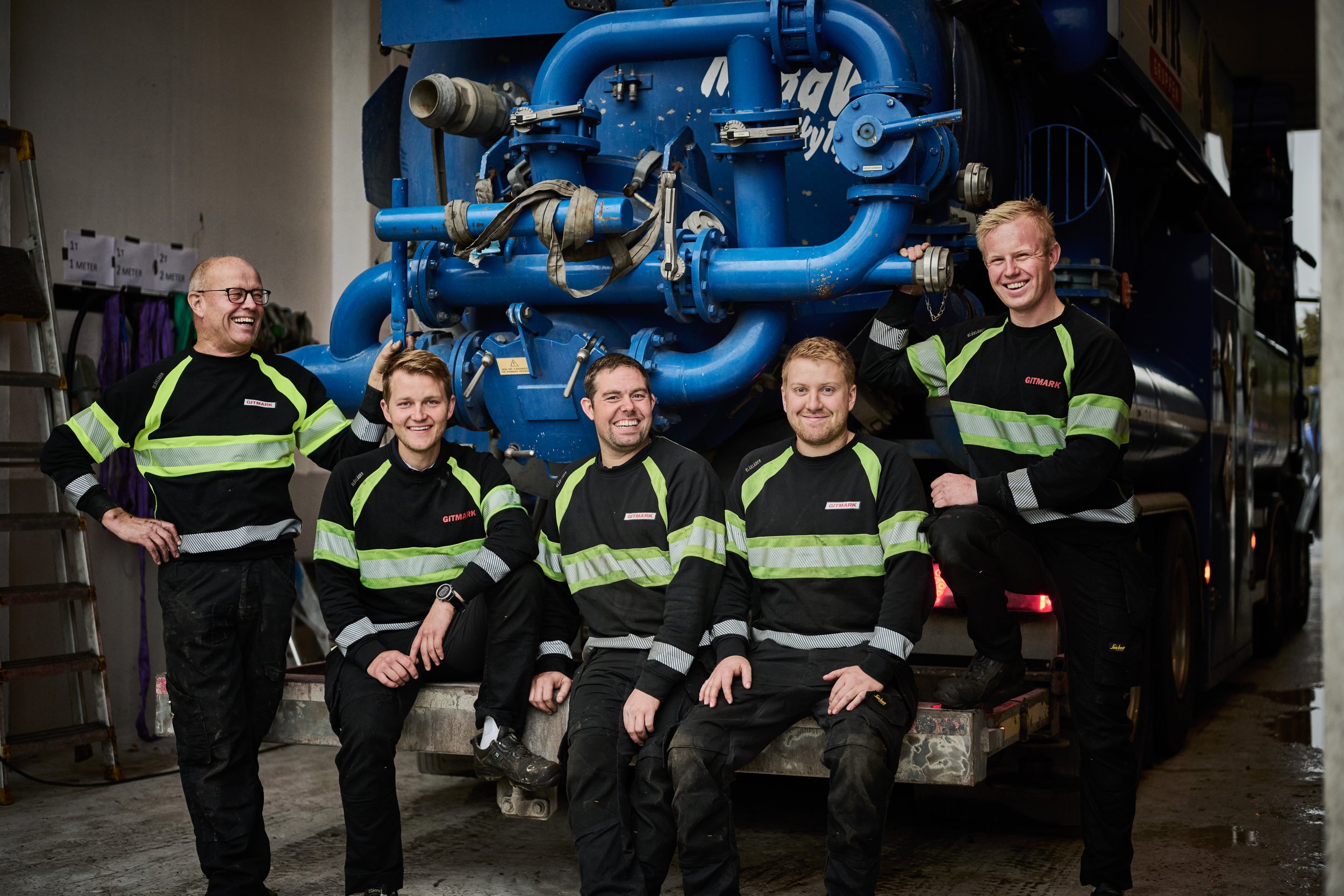 Group portrait of employees in work clothes at machine supplier Gitmark in Norway.
